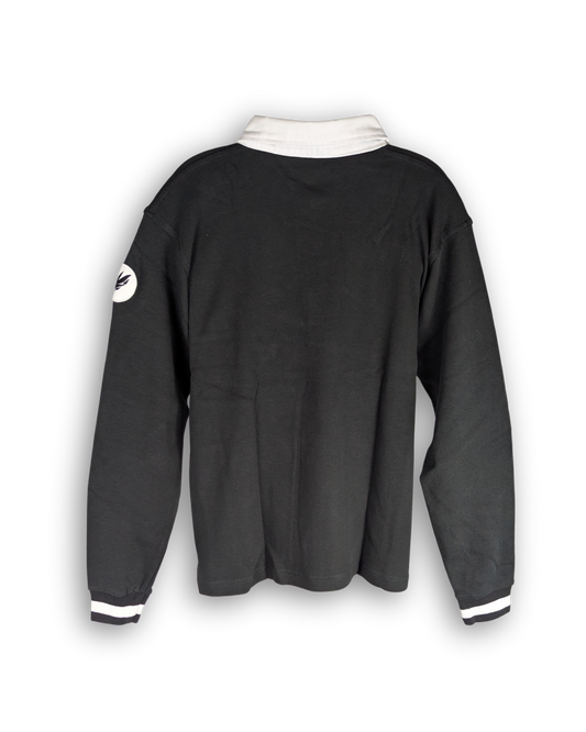 poloshirt mit langen ärmeln in schwarz. bündchen an ärmeln und applikation am rechten ärmel. farbe schwarz. weißer kragen und weißer streifen am bündchen an den ärmeln.